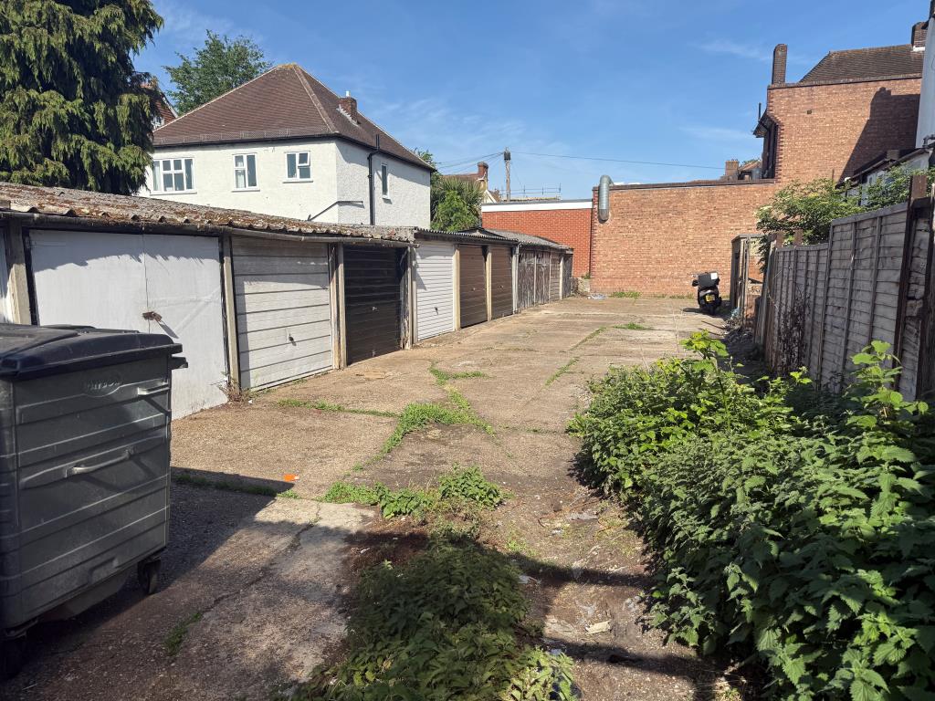 Lot: 17 - FOUR FREEHOLD GARAGES IN A COMPOUND - View of garages and forecourt from east